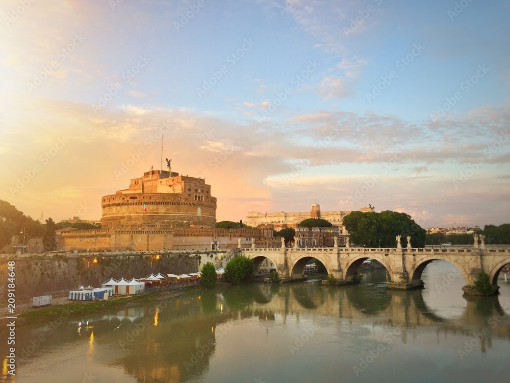 Castel Sant'Angelo and its bridge at sunset in Rome, Italy