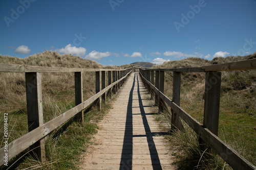 wooden walkway going across special area of conservation sand dune habitat