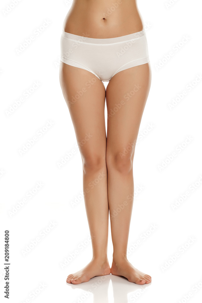 pretty feminine legs and white panties on white background
