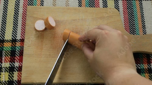 Cutting wieners. First person view. photo