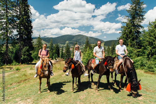 Vászonkép group of people riding horses in the mountains