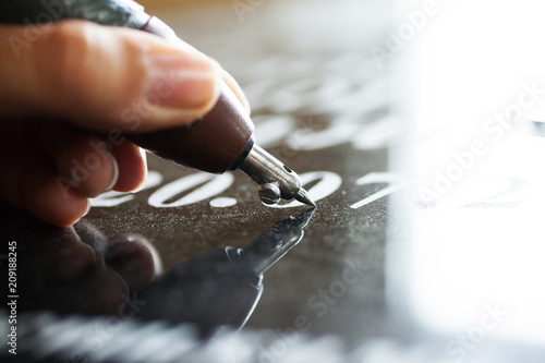 Canvas Print Girl engraves on granite