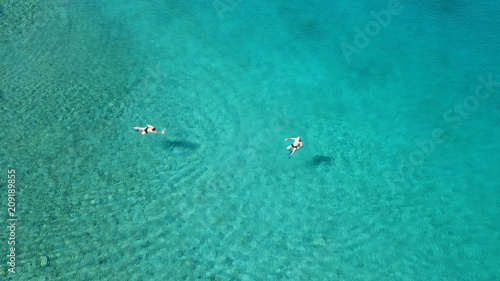 Aerial drone bird's eye view photo from turquoise clear water seascape in island of Shinousa or Schinoussa, Cyclades, Greece © aerial-drone