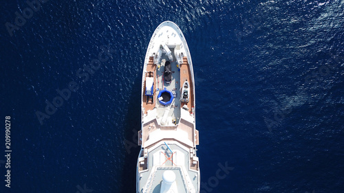 Aerial drone bird's eye view photo of luxury yacht with wooden deck docked in ocean deep blue waters © aerial-drone