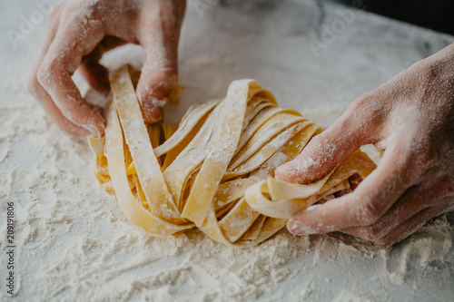 Fototapeta Chef making traditional italian homemade pasta