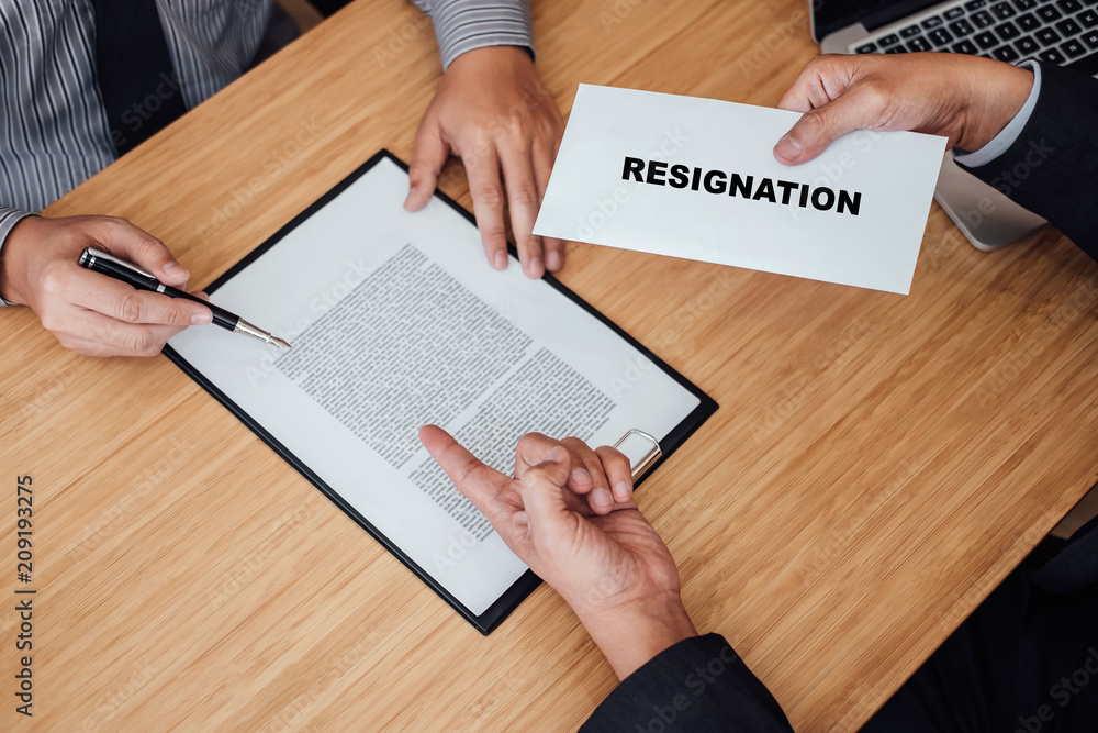 Hand of employer filing final remuneration after employee to write a document letter of resignation, resign concept Hand of employer filing final remuneration after employee to write a document letter of resignation, resign concept