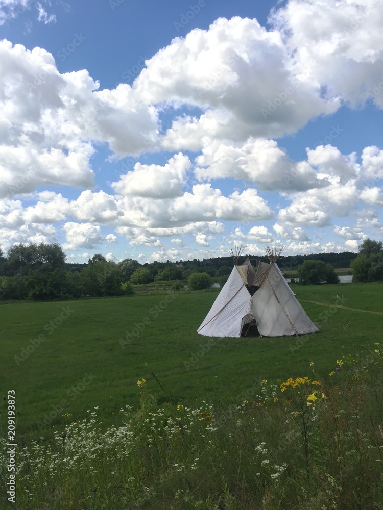 Indian tepee in the field. Summer time