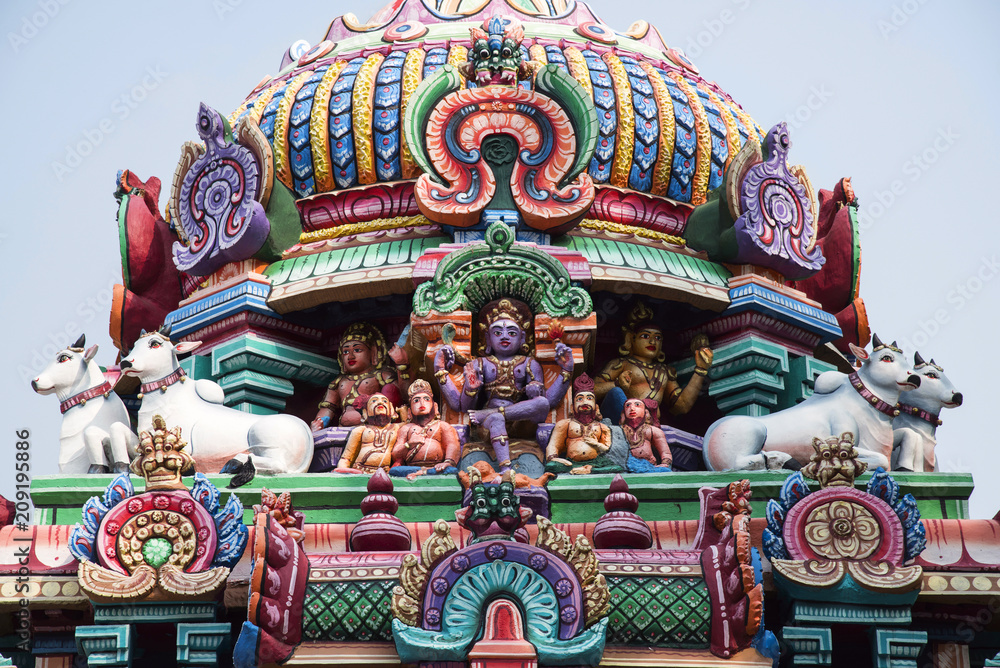 Fototapeta premium Colourful carved gopuram, near Shiva temple, Gangaikonda Cholapuram, Tamil Nadu