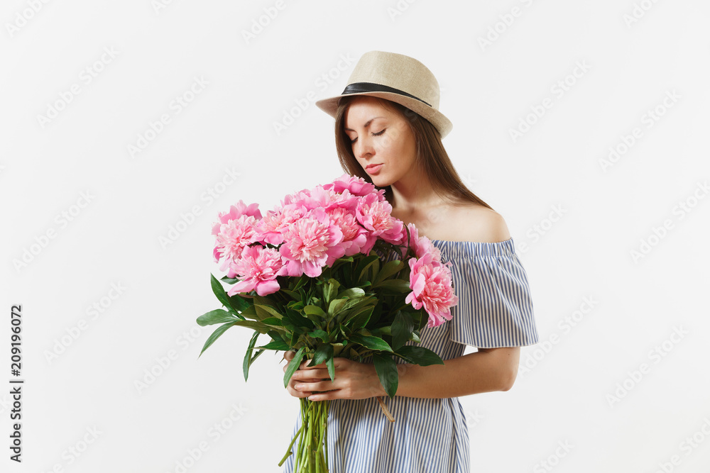 Young tender woman in blue dress, hat holding, sniffing bouquet of pink peonies flowers isolated on white background. St. Valentine's Day, International Women's Day holiday concept. Advertising area. Young tender woman in blue dress, hat holding, sniffing bouquet of pink peonies flowers isolated on white background. St. Valentine's Day, International Women's Day holiday concept. Advertising area.