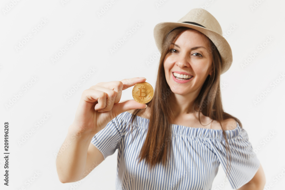 Young elegant woman in blue dress, hat with long hair holding bitcoin, coin of golden color isolated on white background. Finance, business, virtual currency concept. Advertising area. Copy space. Young elegant woman in blue dress, hat with long hair holding bitcoin, coin of golden color isolated on white background. Finance, business, virtual currency concept. Advertising area. Copy space.