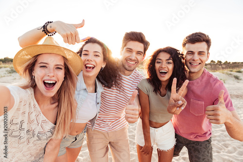 Group of happy young friends in summer clothes photo