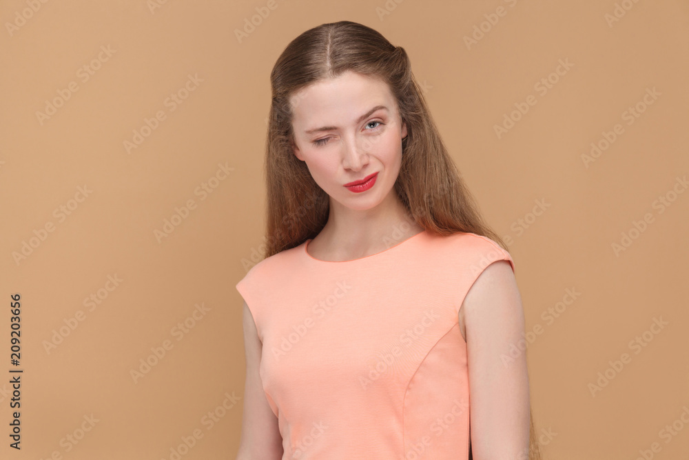 Obraz premium funny woman winking and looking at camera.