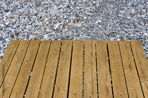 Wooden planks on a pile of pebbles