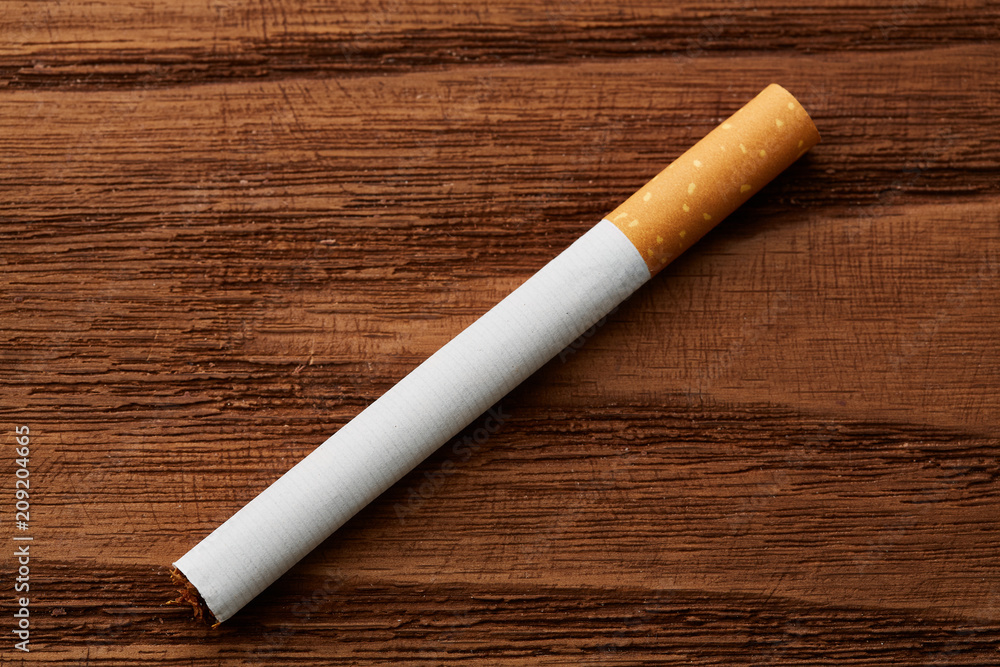 cigarettes close-up on a wooden background. Drug addiction. Smoking of tobacco. cancer. Nicotine. Bad habit. cigarettes close-up on a wooden background. Drug addiction. Smoking of tobacco. cancer. Nicotine. Bad habit.
