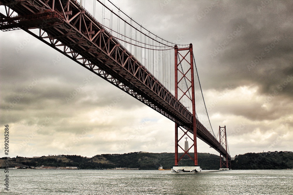 Fototapeta premium 25th April Bridge in Lisbon on a cloudy day