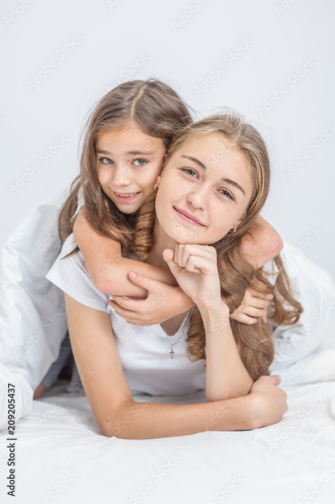 portrait of embracing daughter and mother on bed
