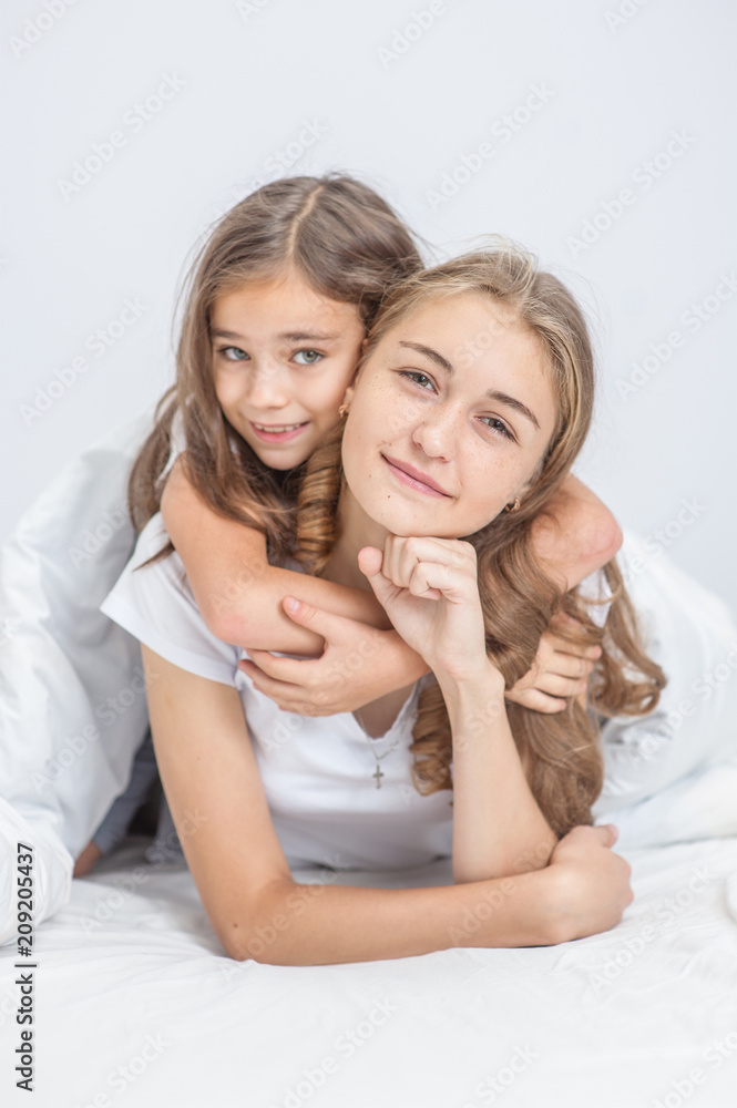 portrait of embracing daughter and mother on bed portrait of embracing daughter and mother on bed