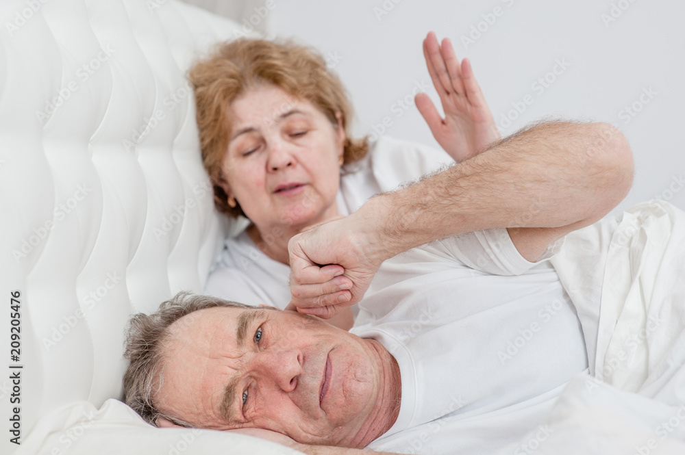 elderly couple is quarreling on the bed elderly couple is quarreling on the bed