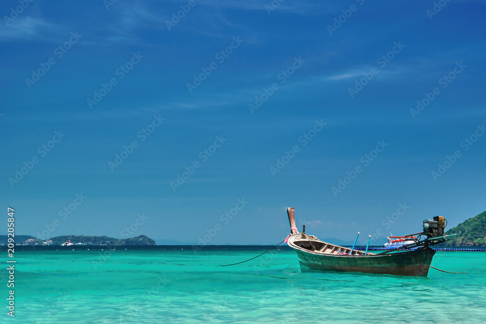 Fishing wooden boat at noon. Tropical sea in the background. Thailand. Panorama landscape.