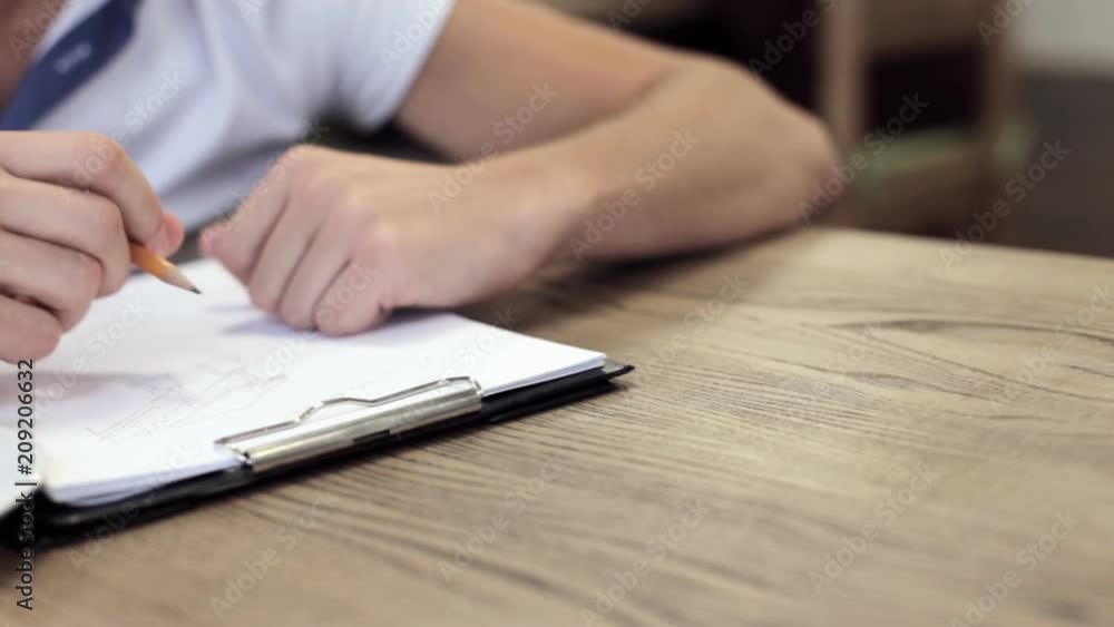 A young engineer makes notes in a magazine A young engineer makes notes in a magazine