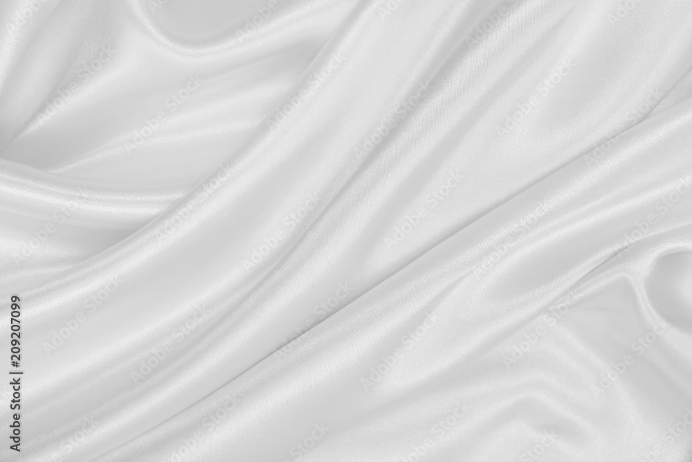 Smooth elegant white silk or satin luxury cloth texture as wedding background. Luxurious Christmas background or New Year background design