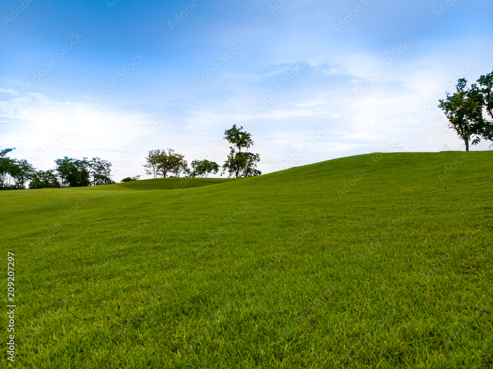 slope hill lay out in green golf course with trees and blue sky slope hill lay out in green golf course with trees and blue sky