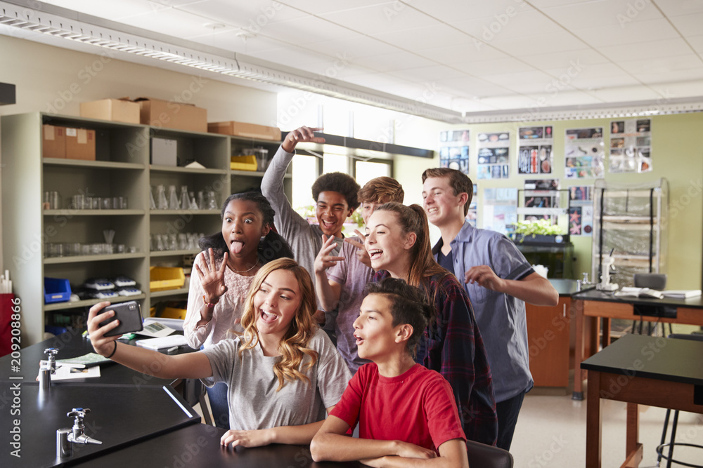 Group Of High School Students Taking Selfie In Biology Classroom Group Of High School Students Taking Selfie In Biology Classroom