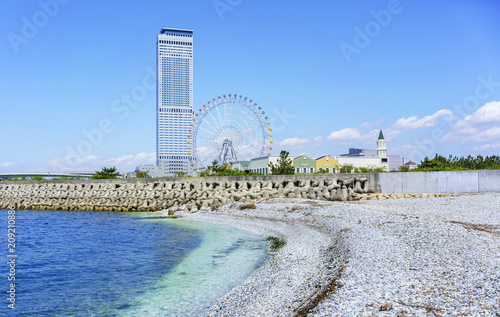 Artificial white marble beach along the shoreline of Rinku Town viewing Rinku Gate Tower Building and Ferris wheel , Osaka , Japan photo