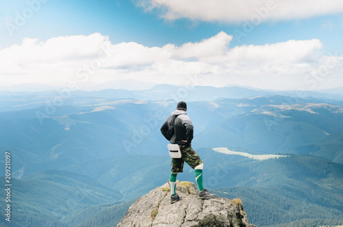 hiker celebrating success on top of a mountain