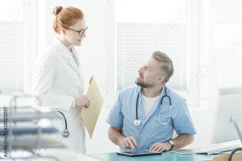 Doctor talking with assistant