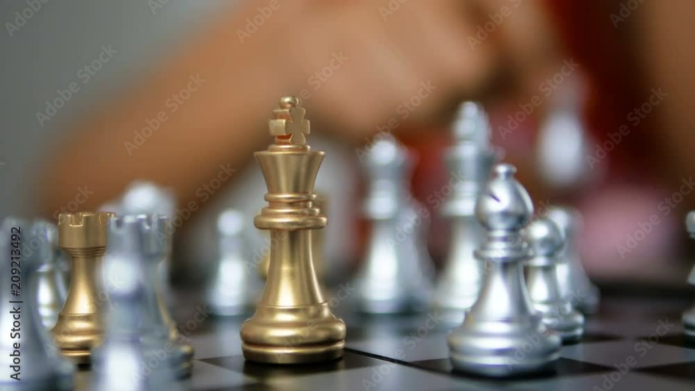 4K Close up shot hands of woman playing golden and silver chess select focus shallow depth of field 4K Close up shot hands of woman playing golden and silver chess select focus shallow depth of field