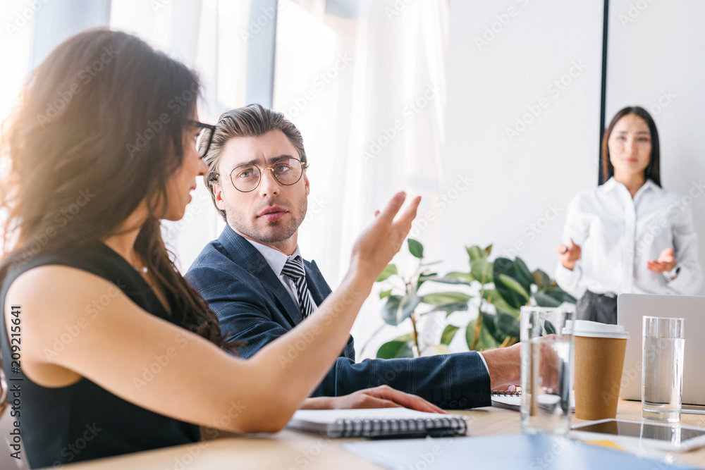selective focus of multiracial businessman and businesswomen working on business project together in office selective focus of multiracial businessman and businesswomen working on business project together in office