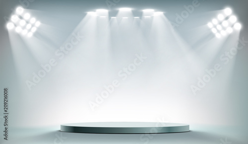 Fotografie, Obraz Round podium illuminated by searchlights.