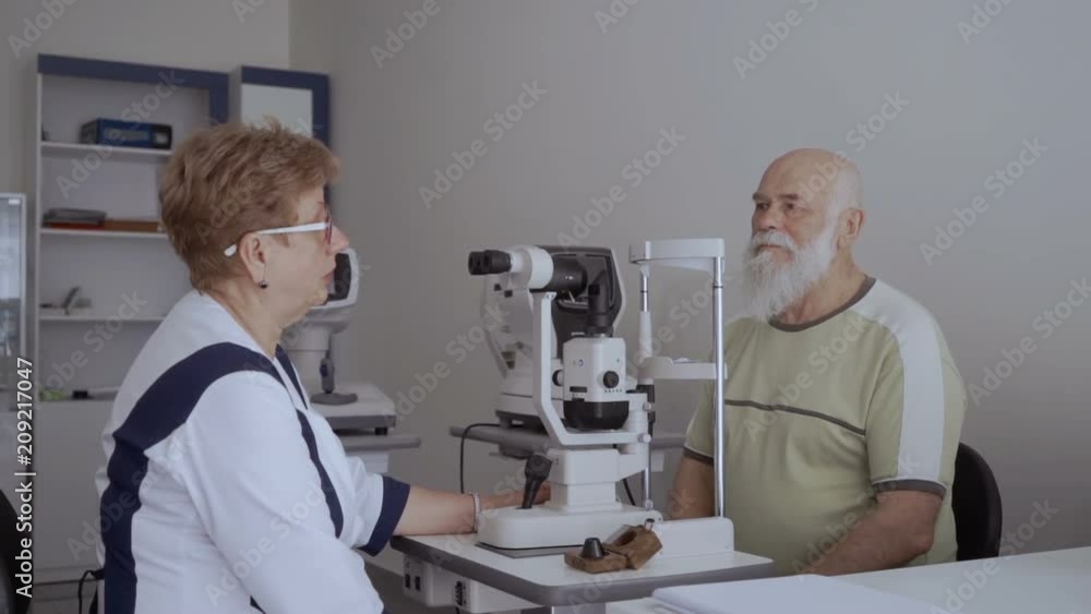 Oculist give consultation to old man Oculist give consultation to old man