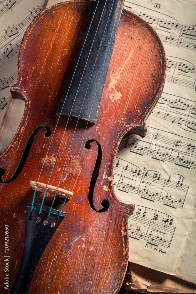 Naklejka premium Closeup of old violin and musical sheets