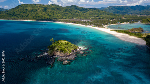 Aerial drone view of beautiful tropical beaches, small islands and surrounding coral reef (Nacpan Beach)