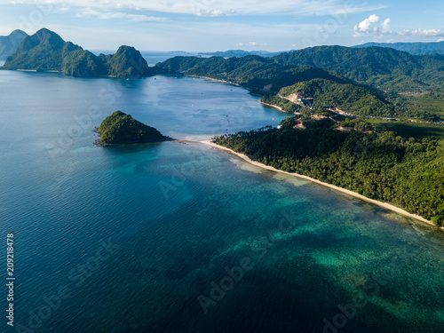 Aerial drone view of a tropical ocean with towering limestone islands (El Nido, Palawan)