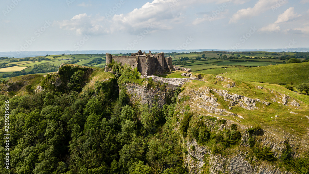 Aerial view of the ruins of an ancient castle on a hilltop (Carreg Cennen, Wales, Britain)