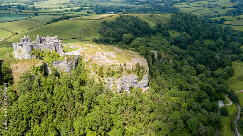 Aerial view of the ruins of Carreg Cennen Castle in the Camarthenshire countryside photo