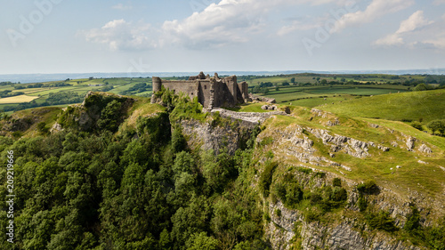 Aerial view of the ruins of an ancient castle on a hilltop (Carreg Cennen, Wales, Britain) photo