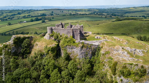 Aerial view of the ruins of an ancient castle on a hilltop (Carreg Cennen, Wales, Britain) photo