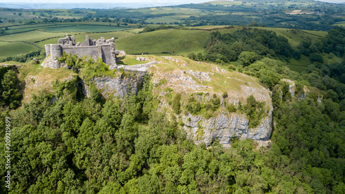 Obraz na plátně Aerial view of the ruins of an ancient castle on a hilltop (Carreg Cennen, Wales
