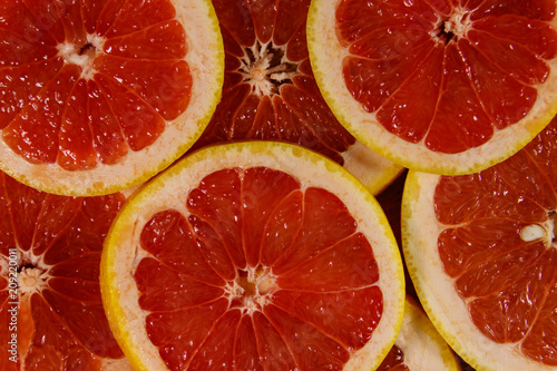 Fresh slices of grapefruits as background