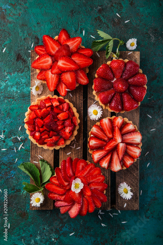 strawberry tartlets  on green background photo