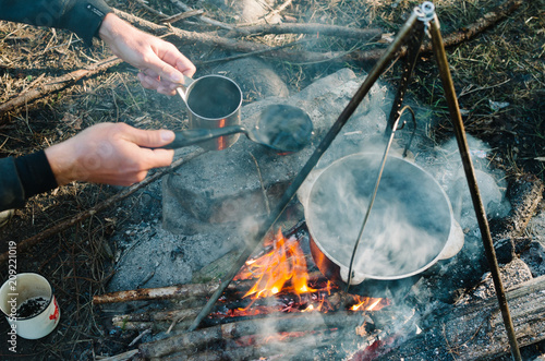 an old way of preparing food above a simple wood fire
