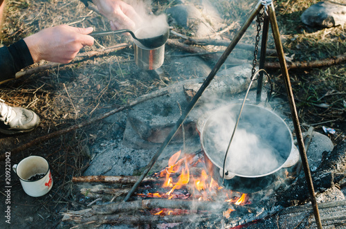 an old way of preparing food above a simple wood fire