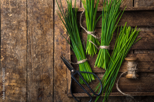 fresh chives on wooden rustic background photo