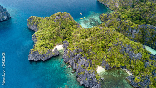 Aerial drone view of a spectacular tropical lagoon with small beaches and jagged cliffs