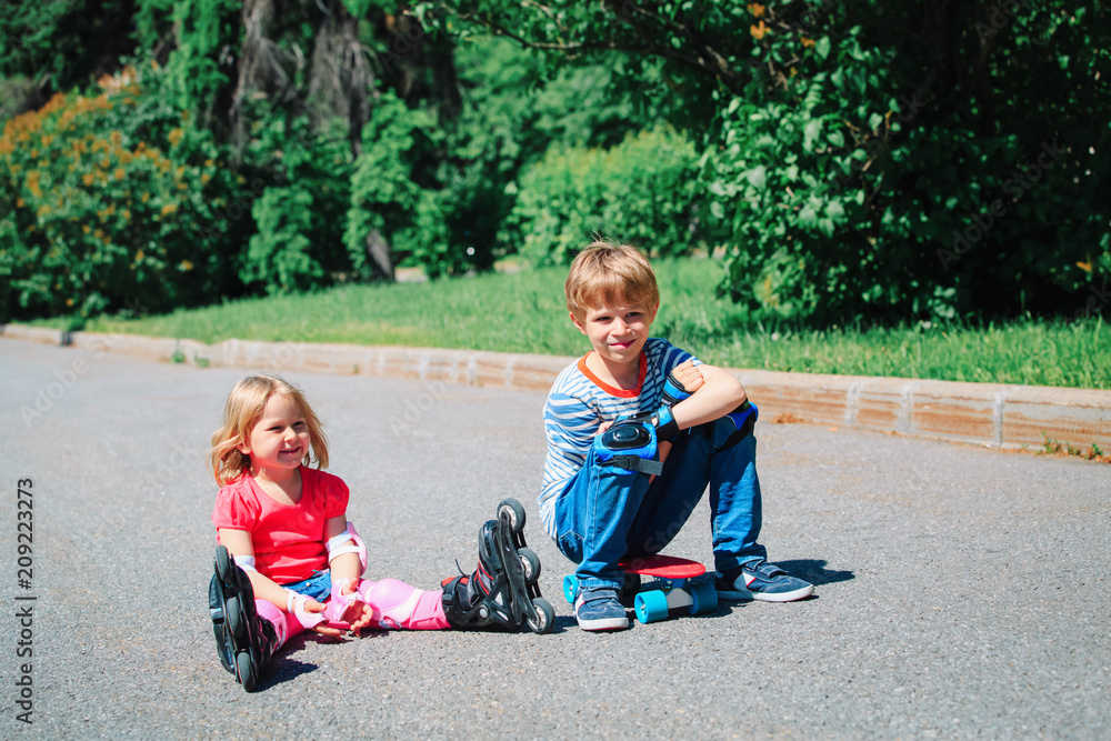 Fototapeta premium happy kids on roller skates and skateboard outside