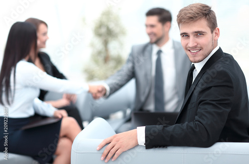 successful business man at the office on the background of business team